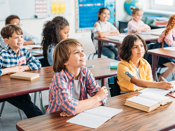 school-aged children sitting in a classroom