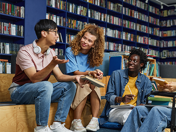 teenagers having a conversation in a library